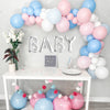 Gender reveal balloon garland party setup. Pink blue and white