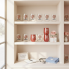 Shelves with various glasses and decorative items in a well-lit room