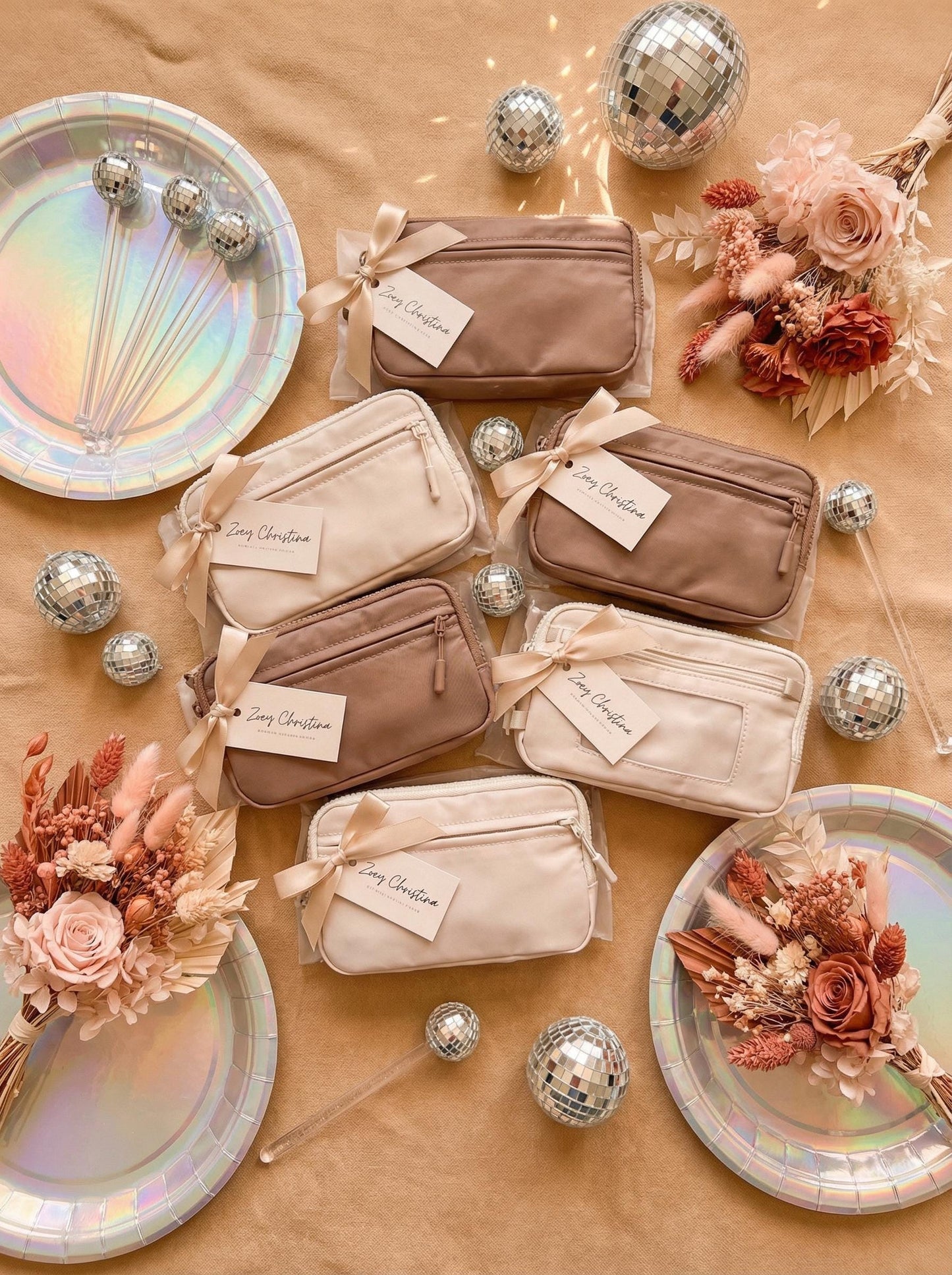 Set of small pouches with ribbons on a decorative surface with flowers and plates.