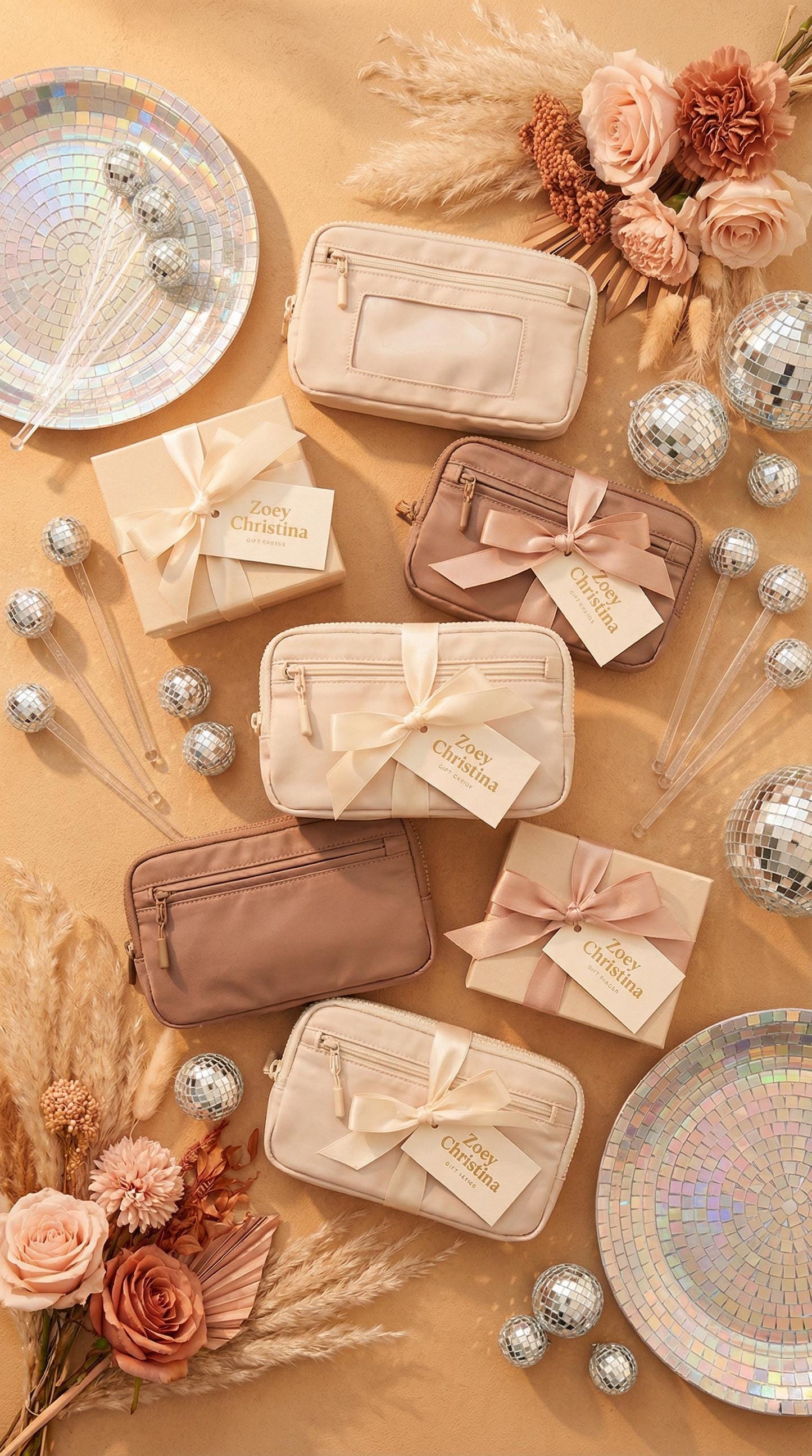 Set of beige and brown cosmetic bags with decorative ribbons on a gold surface with flowers and plates.
